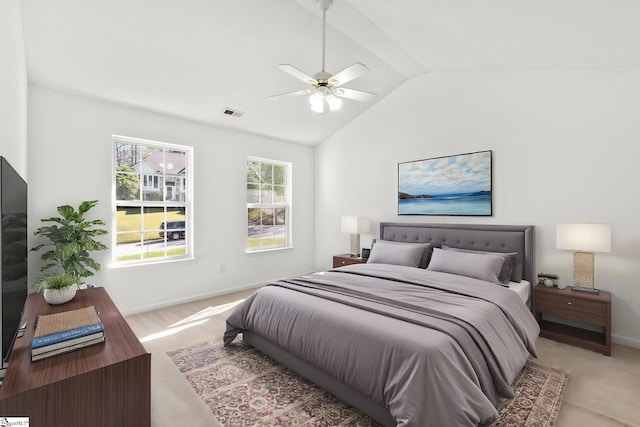 bedroom with baseboards, ceiling fan, light carpet, and lofted ceiling
