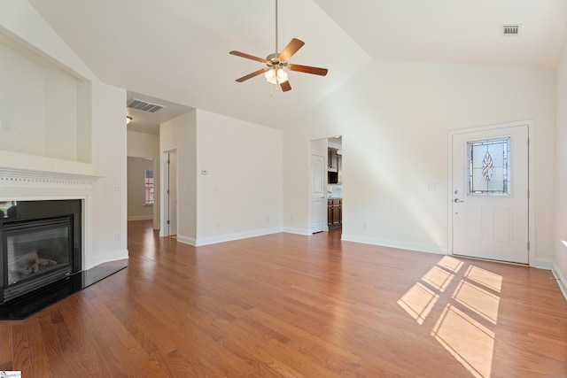 110 Airdale Ln, Simpsonville, SC 29680 - unfurnished living room with a glass covered fireplace, light wood-style flooring, visible vents, ceiling fan, and high vaulted ceiling
