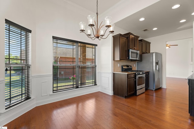 110 Airdale Ln, Simpsonville, SC 29680 - kitchen with visible vents, dark wood-style flooring, dark brown cabinets, stainless steel appliances, and a wainscoted wall