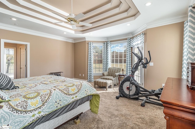 bedroom featuring crown molding, a tray ceiling, recessed lighting, and carpet floors