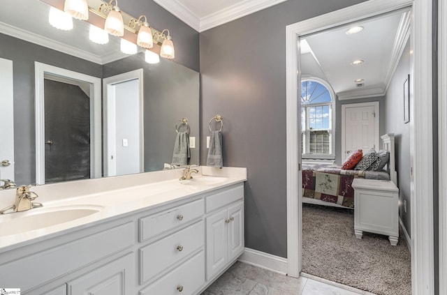 ensuite bathroom with crown molding, a sink, baseboards, and connected bathroom