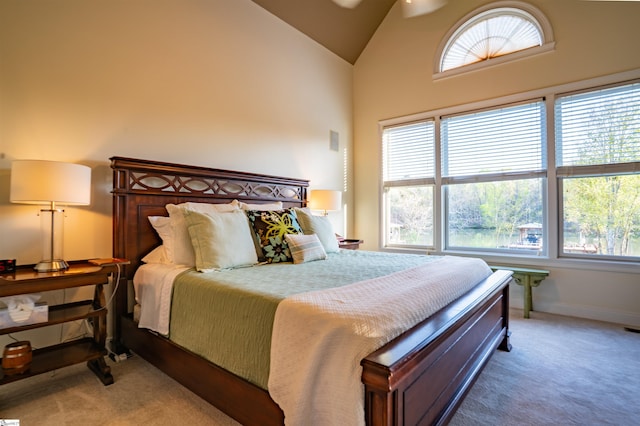 bedroom with visible vents, baseboards, high vaulted ceiling, and light colored carpet