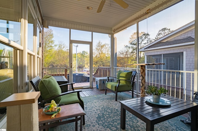 sunroom / solarium featuring a ceiling fan