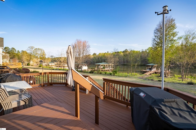 deck featuring a water view and grilling area