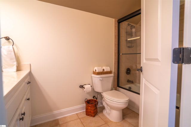 bathroom with vanity, toilet, enclosed tub / shower combo, tile patterned floors, and baseboards