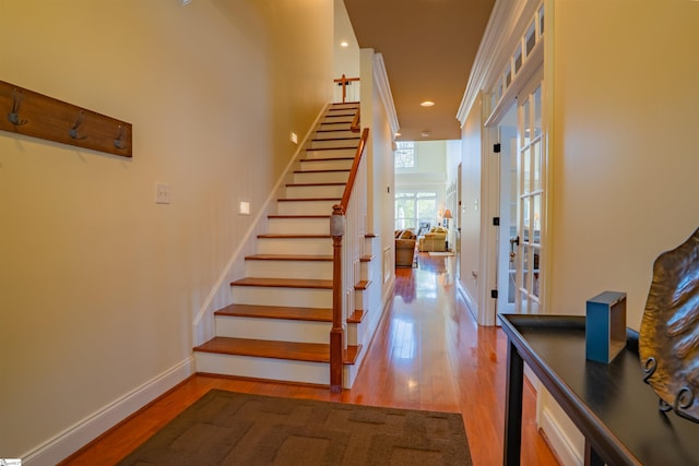 stairs featuring french doors, wood finished floors, baseboards, and recessed lighting