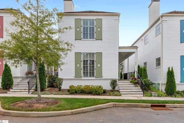 view of front facade featuring a chimney