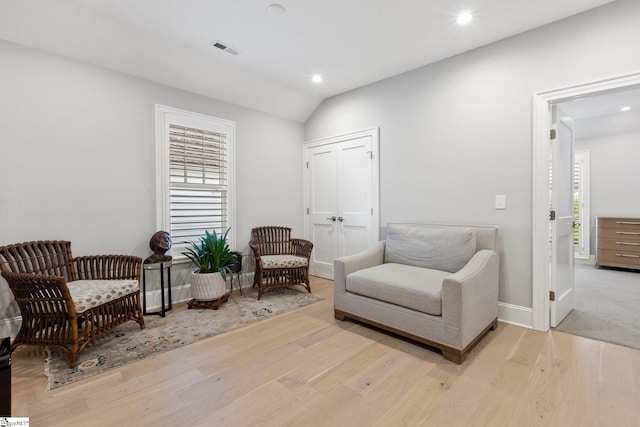 living area featuring baseboards, recessed lighting, visible vents, lofted ceiling, and wood finished floors