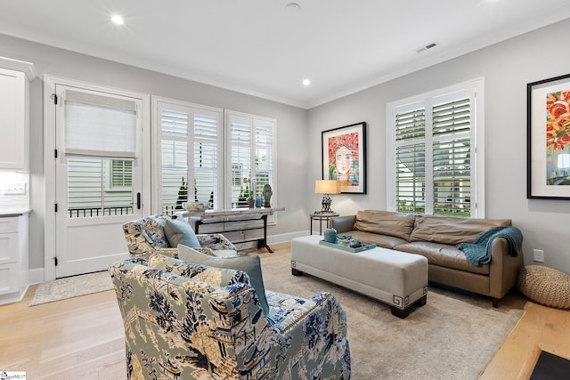 living room featuring crown molding, visible vents, light wood-type flooring, and recessed lighting