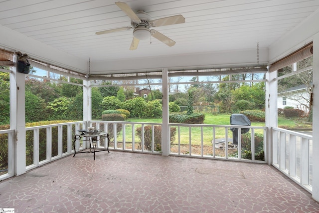 unfurnished sunroom featuring plenty of natural light and ceiling fan
