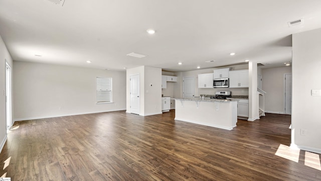 634 Evaleigh St, Woodruff, SC 29388 - unfurnished living room featuring baseboards, dark wood-style floors, visible vents, and recessed lighting