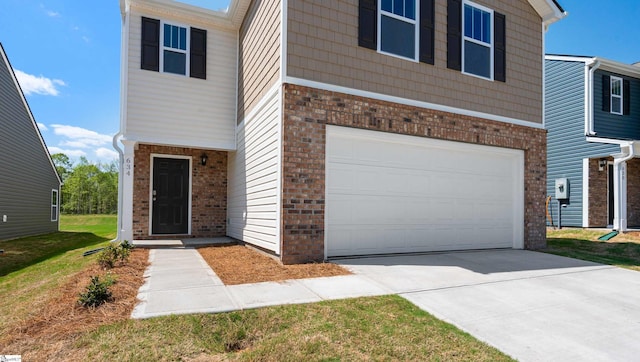 634 Evaleigh St, Woodruff, SC 29388 - view of front of house featuring a garage, brick siding, and driveway