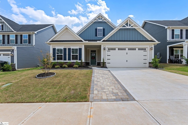 craftsman-style home featuring a front yard, board and batten siding, a garage, and concrete driveway