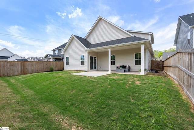 rear view of property featuring a patio area, a fenced backyard, and a lawn