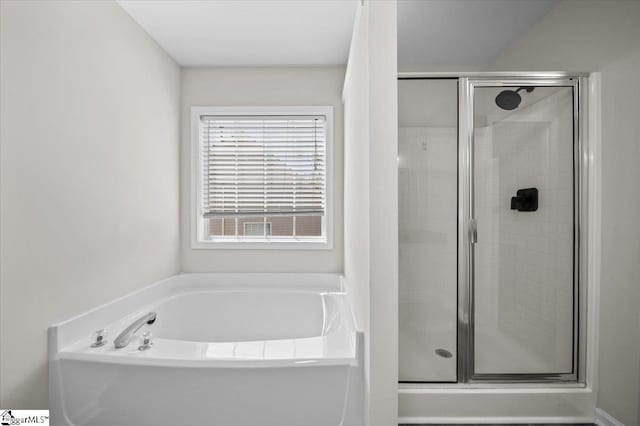 bathroom featuring a garden tub and a stall shower