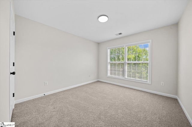 unfurnished room featuring visible vents, baseboards, and carpet floors