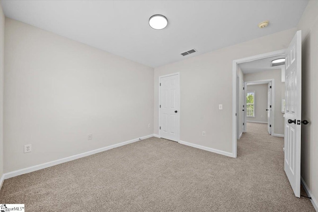 unfurnished bedroom featuring visible vents, baseboards, and carpet flooring