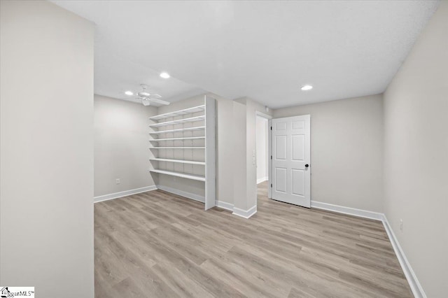 basement featuring baseboards, recessed lighting, and wood finished floors