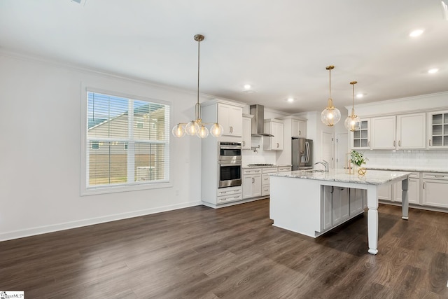 kitchen with ornamental molding, wall chimney range hood, backsplash, and stainless steel appliances