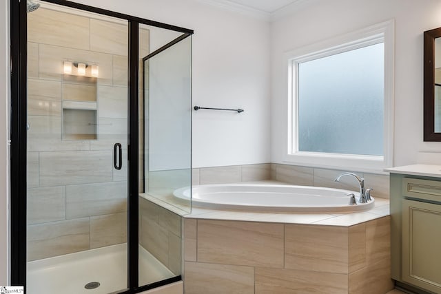 bathroom with a shower stall, a bath, vanity, and crown molding