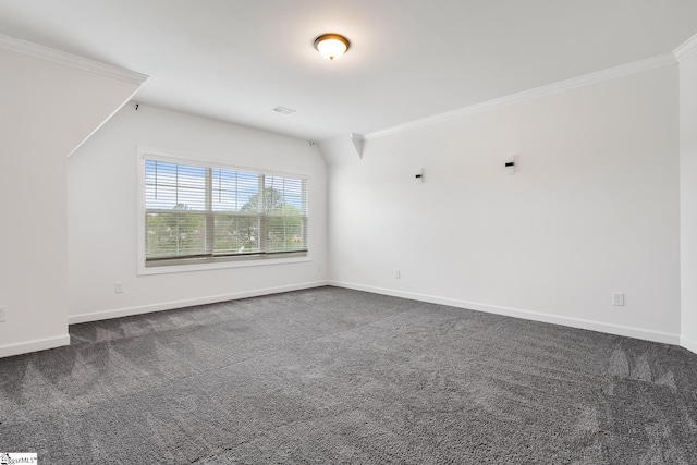 unfurnished room with dark colored carpet, baseboards, and crown molding