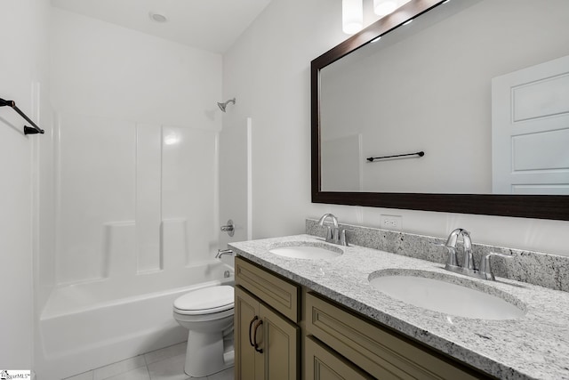 bathroom featuring tile patterned floors, double vanity, a sink, and toilet