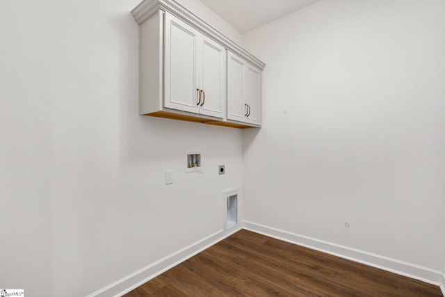 laundry area featuring electric dryer hookup, baseboards, washer hookup, dark wood-type flooring, and cabinet space