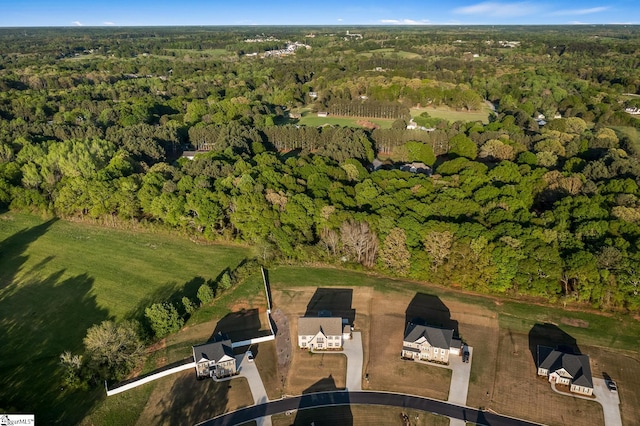 drone / aerial view featuring a forest view