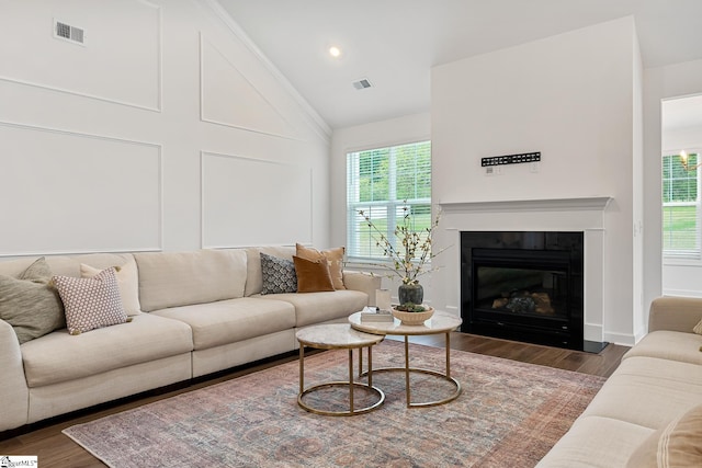 living room with plenty of natural light, visible vents, and wood finished floors