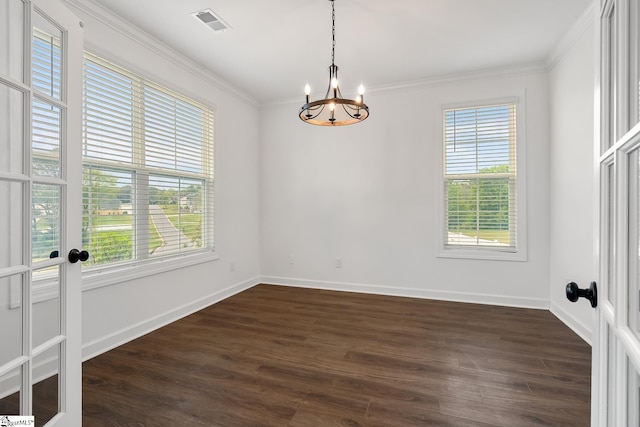 unfurnished room featuring visible vents, baseboards, a chandelier, dark wood finished floors, and crown molding