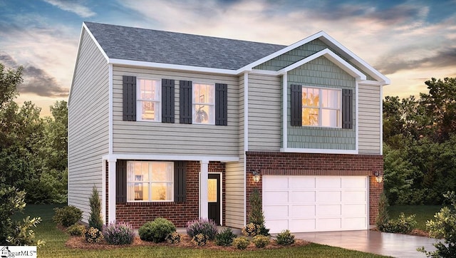 view of front facade with a garage, driveway, and brick siding