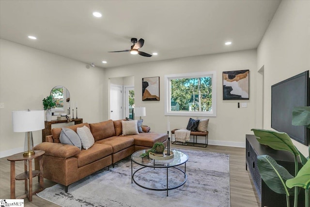living room featuring baseboards, recessed lighting, wood finished floors, and a ceiling fan