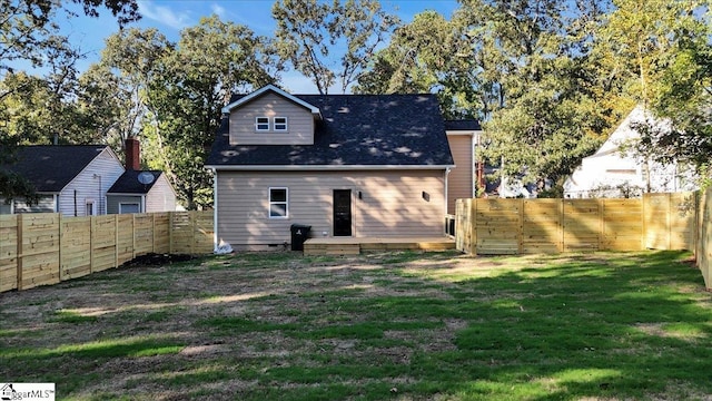 rear view of house featuring a yard, a fenced backyard, a wooden deck, and a gate
