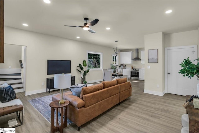 living room with recessed lighting, light wood-type flooring, and a ceiling fan