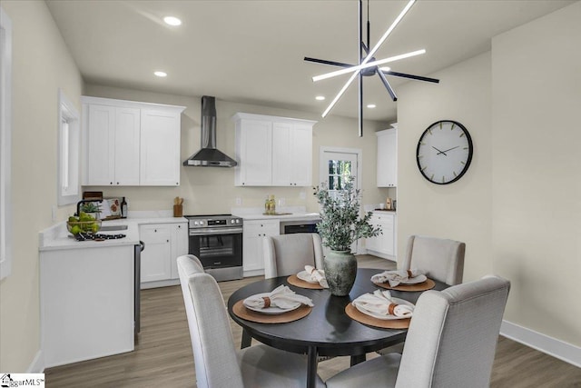 dining area featuring baseboards, recessed lighting, and wood finished floors