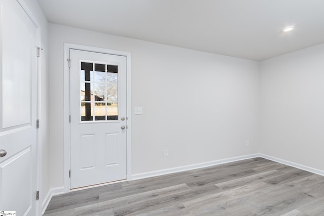 interior space featuring recessed lighting, light wood-style floors, and baseboards