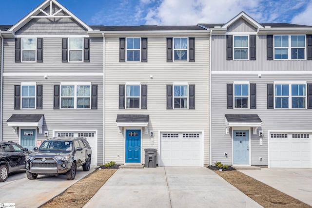 multi unit property with a garage and driveway