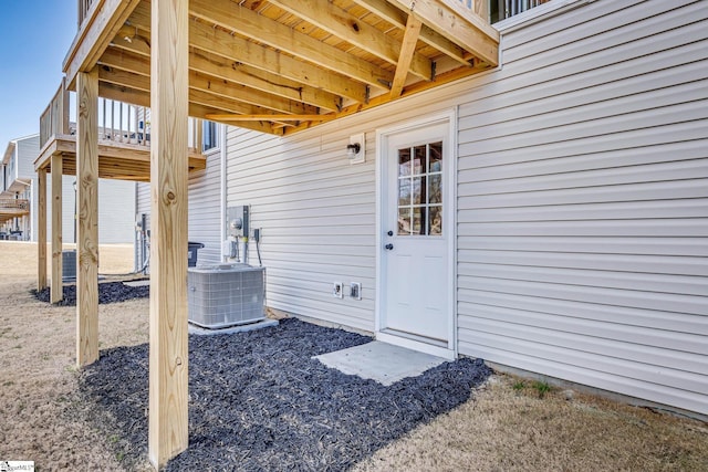 view of exterior entry featuring central AC unit