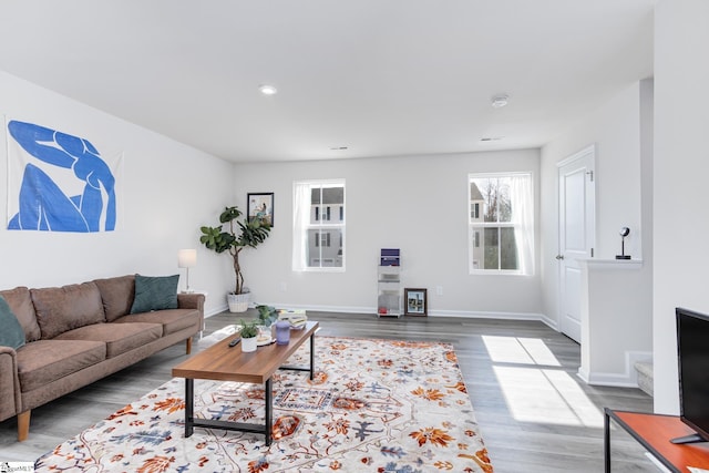 living area featuring wood finished floors, baseboards, and recessed lighting