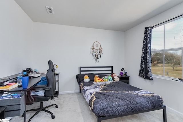 carpeted bedroom with baseboards and visible vents