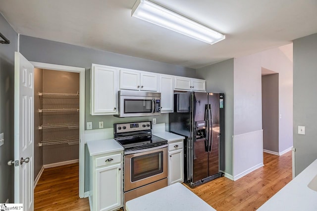 350 Hamilton Pkwy, Easley, SC 29642 - kitchen with light wood-style flooring, light countertops, white cabinetry, and appliances with stainless steel finishes