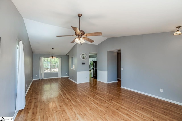 350 Hamilton Pkwy, Easley, SC 29642 - unfurnished living room featuring baseboards, light wood finished floors, ceiling fan with notable chandelier, and vaulted ceiling