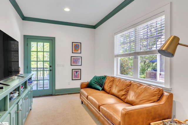 living room with baseboards, light colored carpet, and crown molding
