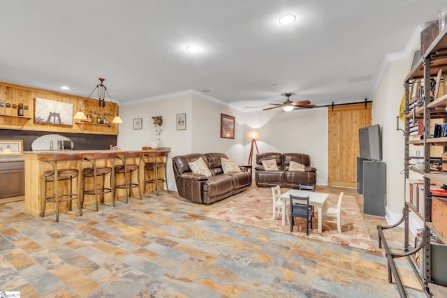 living room with ceiling fan, bar area, ornamental molding, stone finish flooring, and recessed lighting