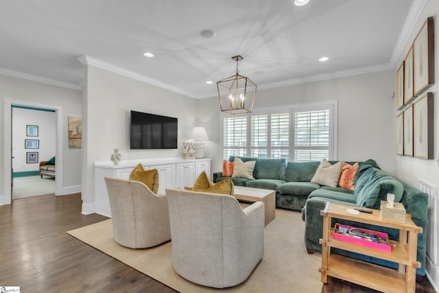 living area featuring crown molding, recessed lighting, an inviting chandelier, and light wood finished floors