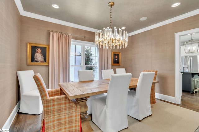 dining room with baseboards, an inviting chandelier, ornamental molding, recessed lighting, and light wood finished floors