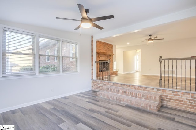 309 Frank St, Easley, SC 29642 - unfurnished living room with wood finished floors, a fireplace, a ceiling fan, and baseboards