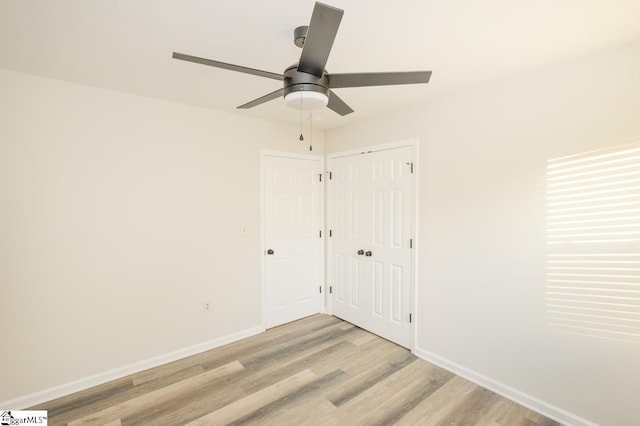 309 Frank St, Easley, SC 29642 - unfurnished bedroom featuring a closet, light wood-style flooring, baseboards, and a ceiling fan