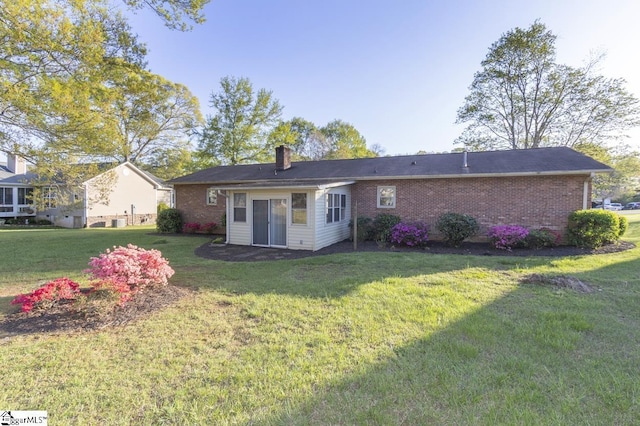 309 Frank St, Easley, SC 29642 - rear view of house featuring a yard, brick siding, and a chimney