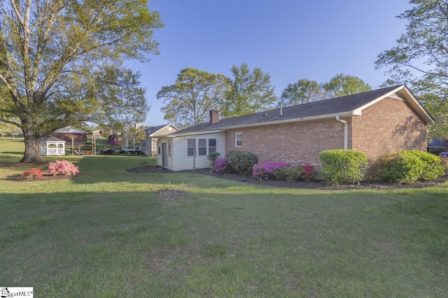 309 Frank St, Easley, SC 29642 - back of house with a yard, brick siding, and a chimney